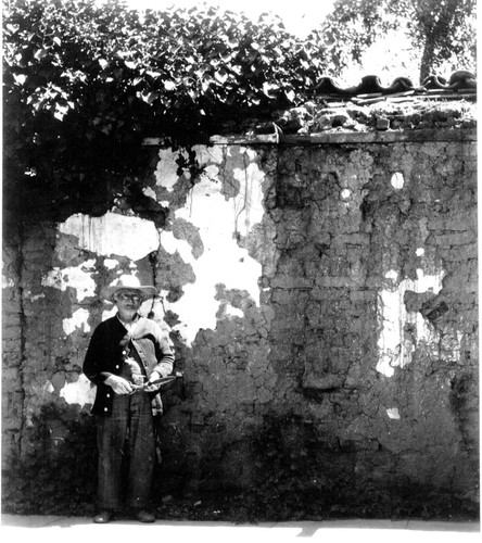 Gardener with shears at the Old Adobe Wall