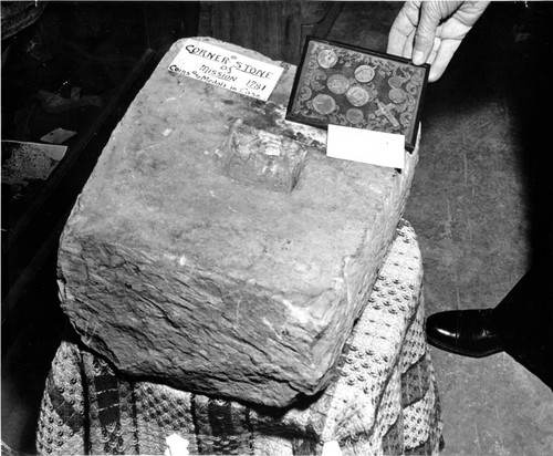 Cornerstone, crucifix, medals and coins from third site of Mission Santa Clara, 1911