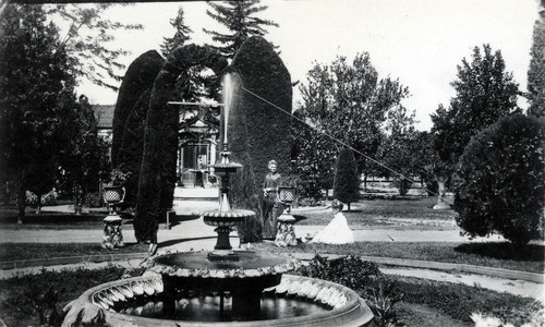 Nimock family in garden with large fountain