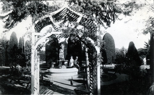 Nimock garden and fountain viewed through trellis entrance