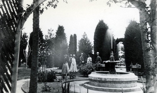 Nimock's garden with family members and fountain in foreground