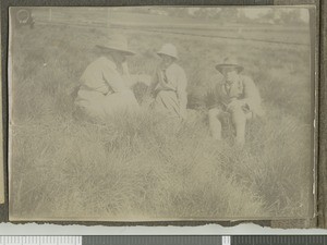 Missionaries sitting in a field, Tumutumu, Kenya, ca.1921