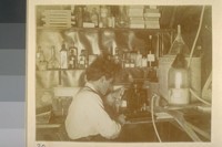 Printing from glass negative in darkroom. [Herman George Scheffauer.]