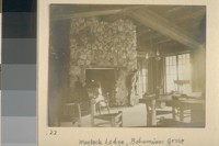 Maybeck Lodge, Bohemian Grove. [Herman George Scheffauer posing by fireplace.]