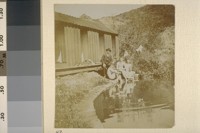 [Man in suit with nude men, beside pond. Herman George Scheffauer, second from left.]