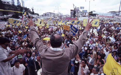 Presidential candidate Ángel Aníbal Guevara shows the victory sign to a crowd of people, Guatemala City, 1982