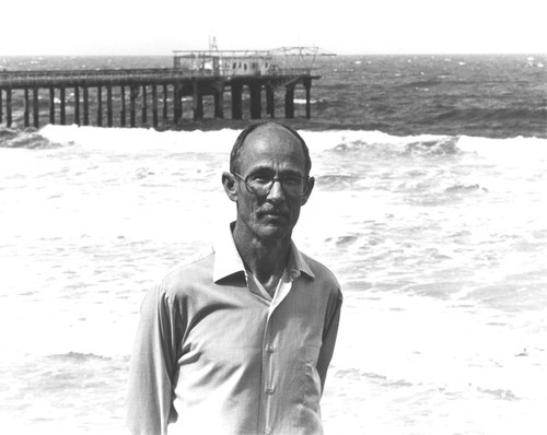 Robert Hessler, standing with Scripps Institution of Oceanography pier in background. n.d