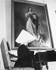 Daughters of Charity non, Los Angeles Orpahange, studying at a desk, 1950