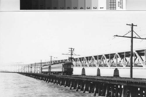 Train on the Key System trestle alongside the recently completed San Francisco-Oakland Bay Bridge [picture]