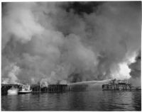 U.S. Navy Tugboat 539 fighting fires that erupted from the Markay oil tanker explosion in L.A. Harbor, Los Angeles, 1947