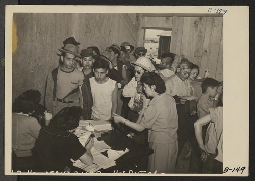 Manzanar, Calif.--Newcomers waiting their turn to be vaccinated at this War Relocation Authority center for evacuees of Japanese ancestry. A personal history is kept of each case in the hospital of which this is a temporary building. Photographer: Albers, Clem Manzanar, California
