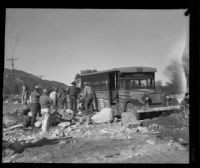 Group of men clearing debris from around a bus after a catastrophic flood and mudslide, La Crescenta-Montrose, 1934