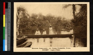 Four missionary fathers seated in a dugout canoe, Benin, ca.1920-1940