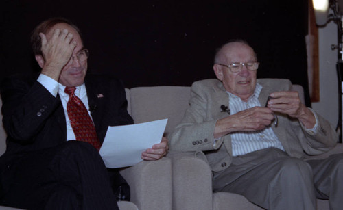 Drucker sits next to John W. Bachmann