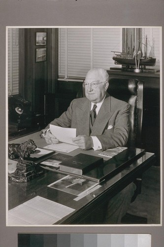 R. Stanley Dollar, President of The Robert Dollar Co., and Dollar Steamship Line, at his desk in his office in