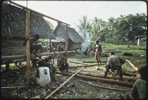 House-building: men take a break from building the frame for a new house