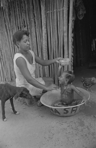 Woman bathing a child, San Basilio de Palenque, 1977