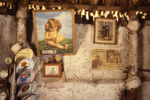 Pictures and dishes hanging from a wall, San Basilio de Palenque, 1976