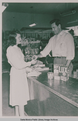 A clerk and a customer with soap products at a store check out counter in Pacific Palisades, Calif