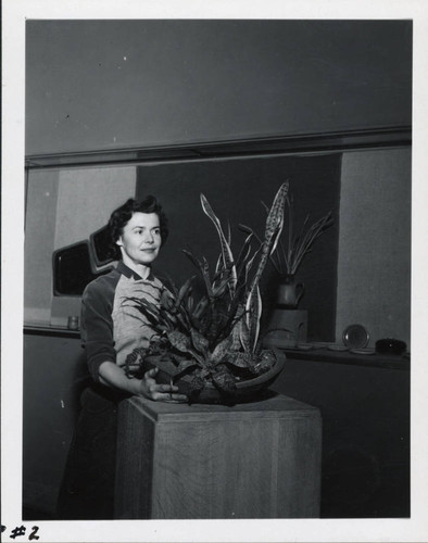 Woman with plant and ceramic potter, Scripps College