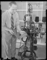 L.R. Bowles demonstrates a sock machine used at a rehabilitation plant for paroled workers, Los Angeles, 1930s