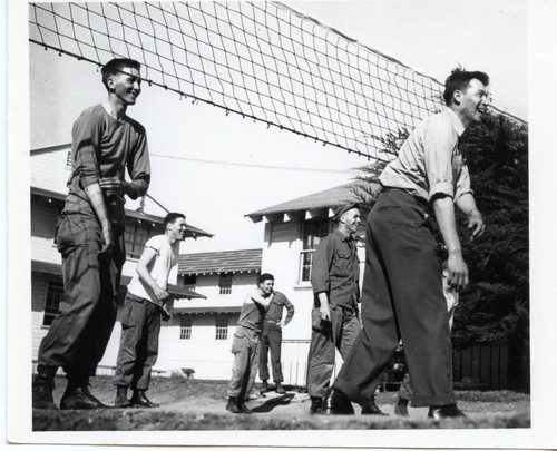 Servicemen playing volleyball at Fort Ord