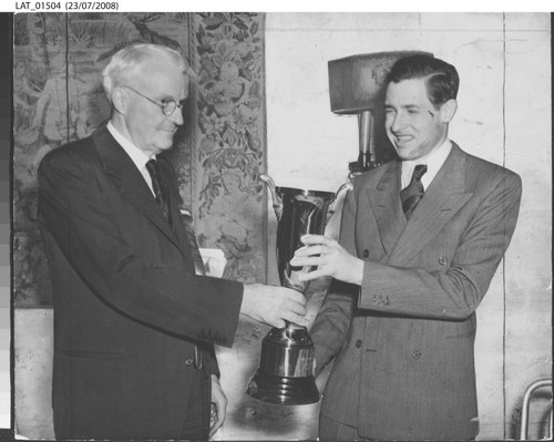 Harry Chandler awards Bill Rogers the Los Angeles Times Cup for best weekly paper front page