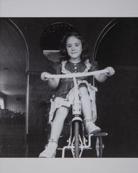 CindyLee Cincera riding her tricycle in Petaluma, California, about 1943