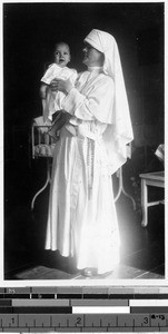Sr. Matthew, MM, holding Benny Quintana at St. Paul's Hospital , Manila, Philippines, 1928