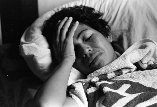 Injured woman in bed, Nicaragua, 1979