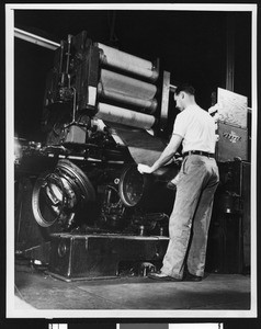 Man making a tire at the United States Rubber Company, ca.1950