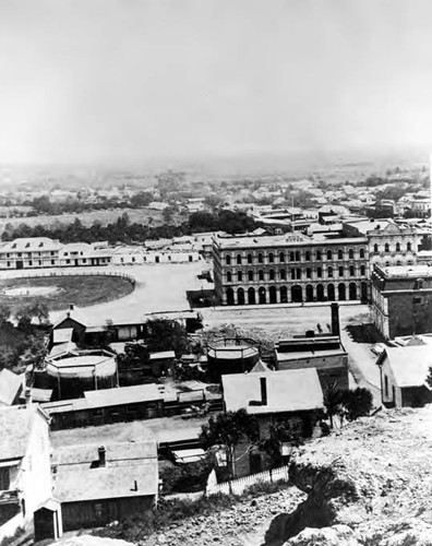 View of Plaza looking east showing the Pico House, L.A. Gas Works, Plaza, and Lugo House