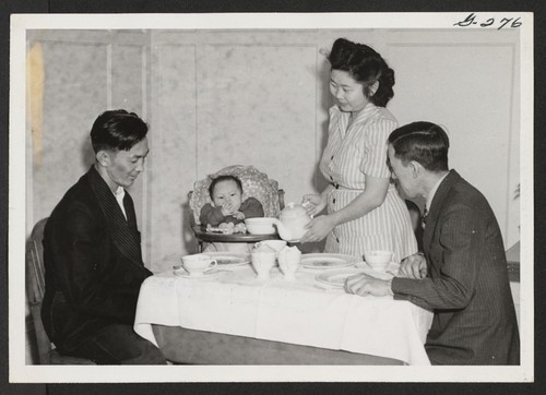 Kaname Fred Ota (left) his wife and nine month old daughter Madeline, and their guest Saburo Tomita at dinner in