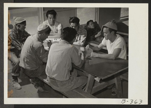 Members of the fire department spend their leisure time by a friendly game of cards. Photographer: Stewart, Francis Topaz, Utah