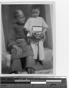An elderly woman with an orphan child at Luoding, China, 1937