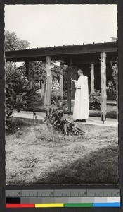 Benedictine monk reading outdoors, Cote d'Ivoire, ca.1920-1940