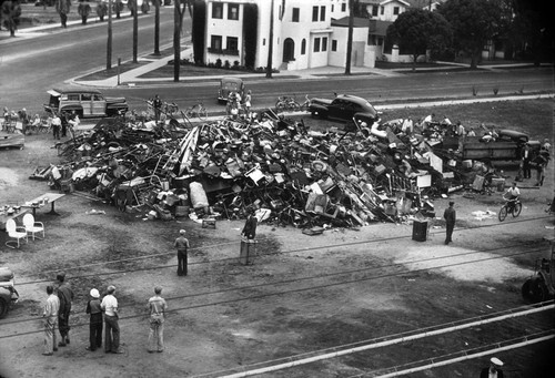 The War Salvage Committee of Coronado collects over twenty tons of metal, rubber, grease and newspapers piled at the corner of 6th and Palm to be converted to war needs, Coronado, 1942