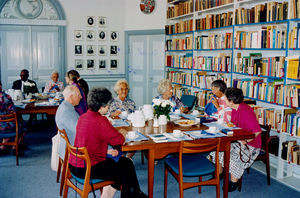 India Kredssen with Bishop Franklin. front table from left: Helga Olesen, Ragnhild Bindslev, Es