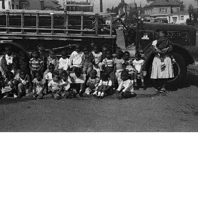 Students seated in front of fire engine