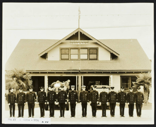 Crew in dress uniforms form line in front of Station No. 3, 526 E. Anaheim St