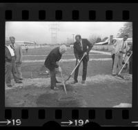 Mayor Tom Bradley and actor Eddie Albert tilling soil at dedication of community garden in Reseda, Calif., 1975