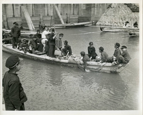 Schoolchildren on long, narrow boat
