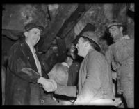 Two miners shaking hands after the completion of the San Jacinto tunnel, Banning, 1938