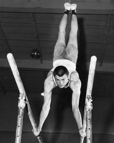 Poly's Chuck Casey on parallel bars