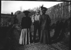Two women and on man waiting for the P&SR train near Baker Lane, about 1904