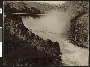 Man walking on a bridge over the La Grange Dam near Modesto in Stanislaus County, 1900-1940