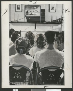 Teenagers watch sports on church-operated video screen, 1948
