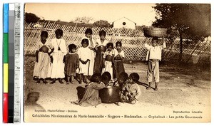 Orphans in a fenced-in yard, Nagpur, India, ca.1920-1940