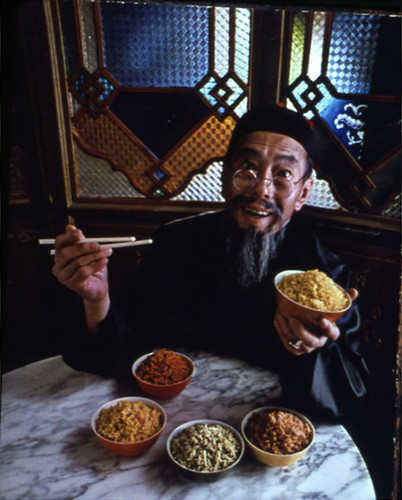 Chinese person showing many bowls of rice — Calisphere