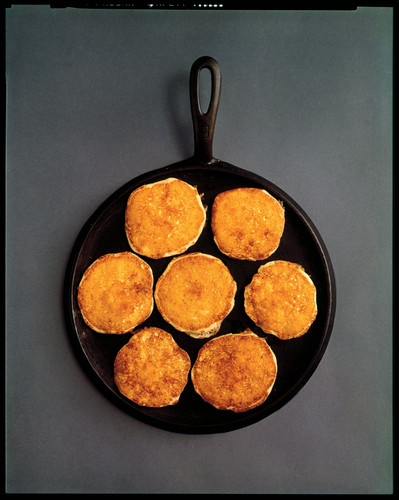 Seven pancakes in a round cast iron pan